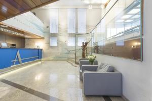 a lobby with couches and a map on the wall at c-hotels Atlantic in Milan