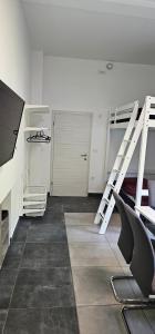a room with two bunk beds and a tv at Apartma Marija in Kranjska Gora +8 photos