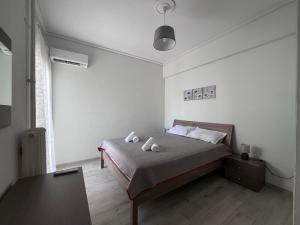 a bedroom with a bed with two pillows on it at Miranda's Apartment Koukaki in Athens