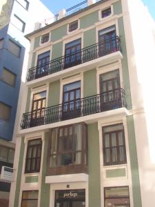 a green building with balconies on the side of it at Coroa del Mar in Valencia