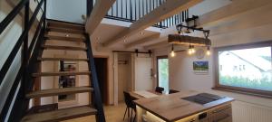 an office with a wooden desk and a spiral staircase at Green Garden Apartment in Bled