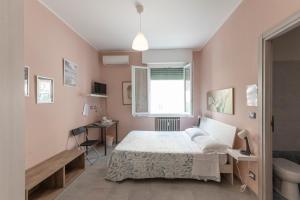 a bedroom with a bed and a window and a sink at FARE BnB - Room & Breakfast Santa Maria in Reggio Emilia