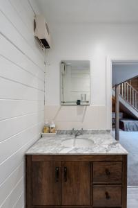 a bathroom with a sink and a mirror at Walliswood Lodge - Wood Burner, Air Con & Wi-fi, Rural Retreat in Ewhurst +81 photos