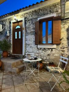 a table and two chairs in front of a house at Afroditi's 1 in Eresos
