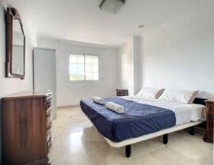 a bedroom with a bed and a dresser and a window at a beautiful and tranquil apartment in the heart of marbella in Marbella +13 photos