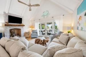 a living room with a couch and a fireplace at High Seas in DeBordieu Colony home by Peace Vacations in Georgetown