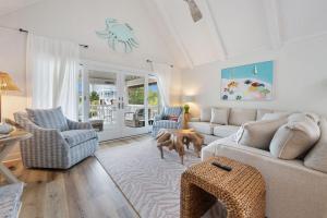 a living room with a couch and a table at High Seas in DeBordieu Colony home by Peace Vacations in Georgetown