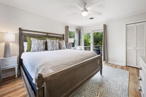 a bedroom with a large bed with a ceiling fan at High Seas in DeBordieu Colony home by Peace Vacations in Georgetown