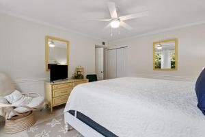 a bedroom with a bed and a dresser and a television at High Seas in DeBordieu Colony home by Peace Vacations in Georgetown