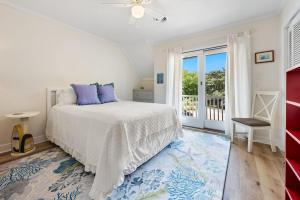 a bedroom with a bed and a balcony at High Seas in DeBordieu Colony home by Peace Vacations in Georgetown