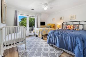 a bedroom with two beds and a balcony at High Seas in DeBordieu Colony home by Peace Vacations in Georgetown