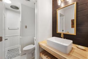a bathroom with a white sink and a mirror at High Seas in DeBordieu Colony home by Peace Vacations in Georgetown