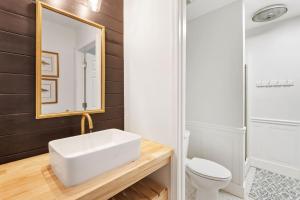 a bathroom with a white sink and a mirror at High Seas in DeBordieu Colony home by Peace Vacations in Georgetown