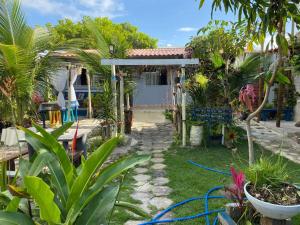 a garden with plants in front of a house at Casinha Azul in Prado