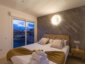 a bedroom with a large bed with towels on it at Giraud I - Luxurious secluded villa next to the sea in Lajares +37 photos