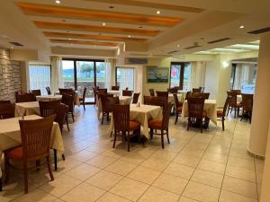 a dining room with tables and chairs in a restaurant at Europa Beach Hotel in Galaxidi