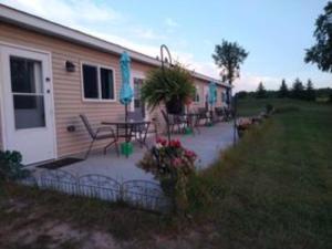 a house with a patio with a table and umbrella at Beach Mirage Suites , Rm #4 in Brook Park