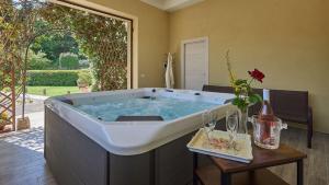 a large bath tub in a living room with a table at Il Boschetto in Radda in Chianti +32 photos