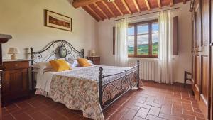 a bedroom with a bed and a window at Il Boschetto in Radda in Chianti
