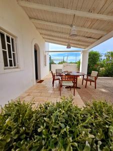 a patio with a table and chairs on it at BOUCANVILLE in Polignano a Mare