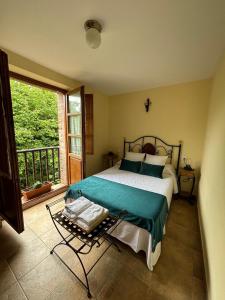 a bedroom with a bed and a large window at La Casa Grande de Cabrales II in Canales