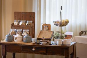 a table with jars and other items on it at Hotel Massimo in Marina di Cecina