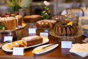 a table with different types of cakes and pastries at Hotel Massimo in Marina di Cecina