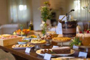 a table filled with different types of food on plates at Hotel Massimo in Marina di Cecina