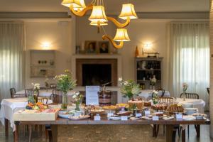 a long table with many different foods on it at Hotel Massimo in Marina di Cecina