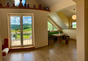 a living room with a large window and a table at U Daszków in Zawory