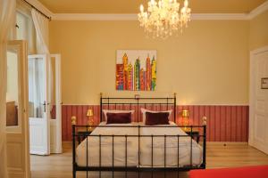 a bedroom with a bed and a chandelier at Anno 1900 Hotel Babelsberg in Potsdam