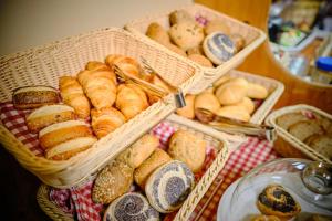 three baskets filled with different types of pastries on a table at Anno 1900 Hotel Babelsberg in Potsdam