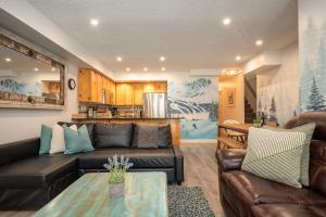a living room with a couch and a table at Spacious Home in an Amazing Location by Harmony Whistler in Whistler