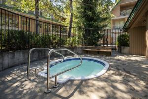 a hot tub with a hand rail in a yard at Spacious Home in an Amazing Location by Harmony Whistler in Whistler