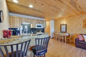 Una cocina y una sala de estar con mostrador y sillas. en Near Skiing Studio with Pool Access in Granby!, en Granby