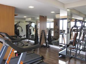a gym with tread machines and a mirror at RCM Vilas - Studio Surf 606 in Joinville