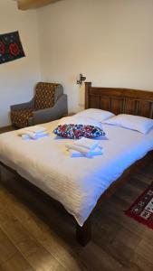a large bed with two pillows on top of it at Casa Loredana in Vadu Izei
