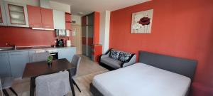 a small room with a bed and a table and a kitchen at Sirena Holidays in Ravda