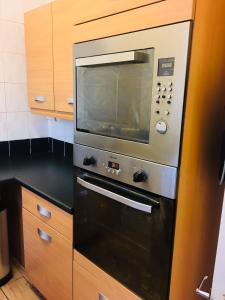 a microwave oven sitting on top of a kitchen counter at Hagley Road West House in Birmingham