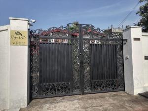 a black gate with a sign in front of it at Sujee Villa CeylonHub in Beruwala