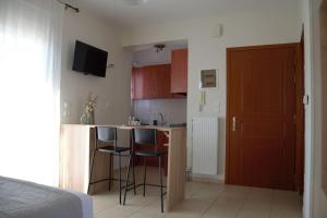 a room with a kitchen with a bed and a counter at Welina guesthouse in Volos