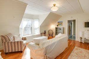 a living room with a white couch and chairs at Charming Saco Apartment about 4 Mi to the Beach! in Saco