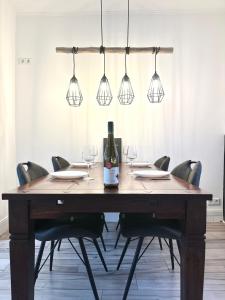a dining room table with glasses and a bottle of wine at Ferienhaus Zur Gasse in Zell an der Mosel