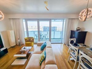 a living room with a couch and a table at Al Raha Serenity - Spacious 2BR Getaway Near Yas Island & Al Raha Beach in Abu Dhabi