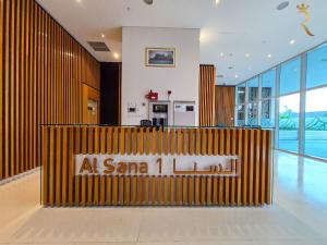 a lobby with a sign that reads at santa inn at Al Raha Serenity - Spacious 2BR Getaway Near Yas Island & Al Raha Beach in Abu Dhabi +37 photos