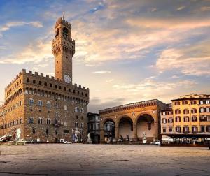 a building with a clock tower on top of it at Le Cure in Florence