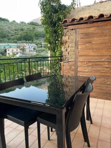 a black table and chairs on a balcony at Vicolo Antico in Vico nel Lazio +10 photos