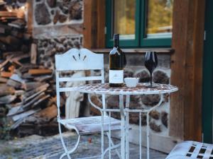 a table with a bottle of wine and a glass at Remark Studios - Studio-Apartment Seehaus in Burgwedel