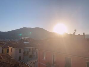 a view of the sun setting over a city at 98 House in La Spezia