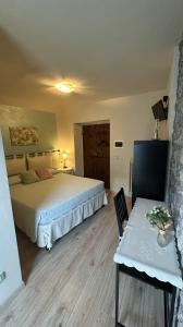 a bedroom with a bed and a table and a chair at B&B Baldì in Pertica Alta